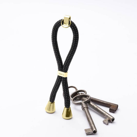 Reflektierender Schlüsselanhänger mit goldenem Slider und Endstücken.