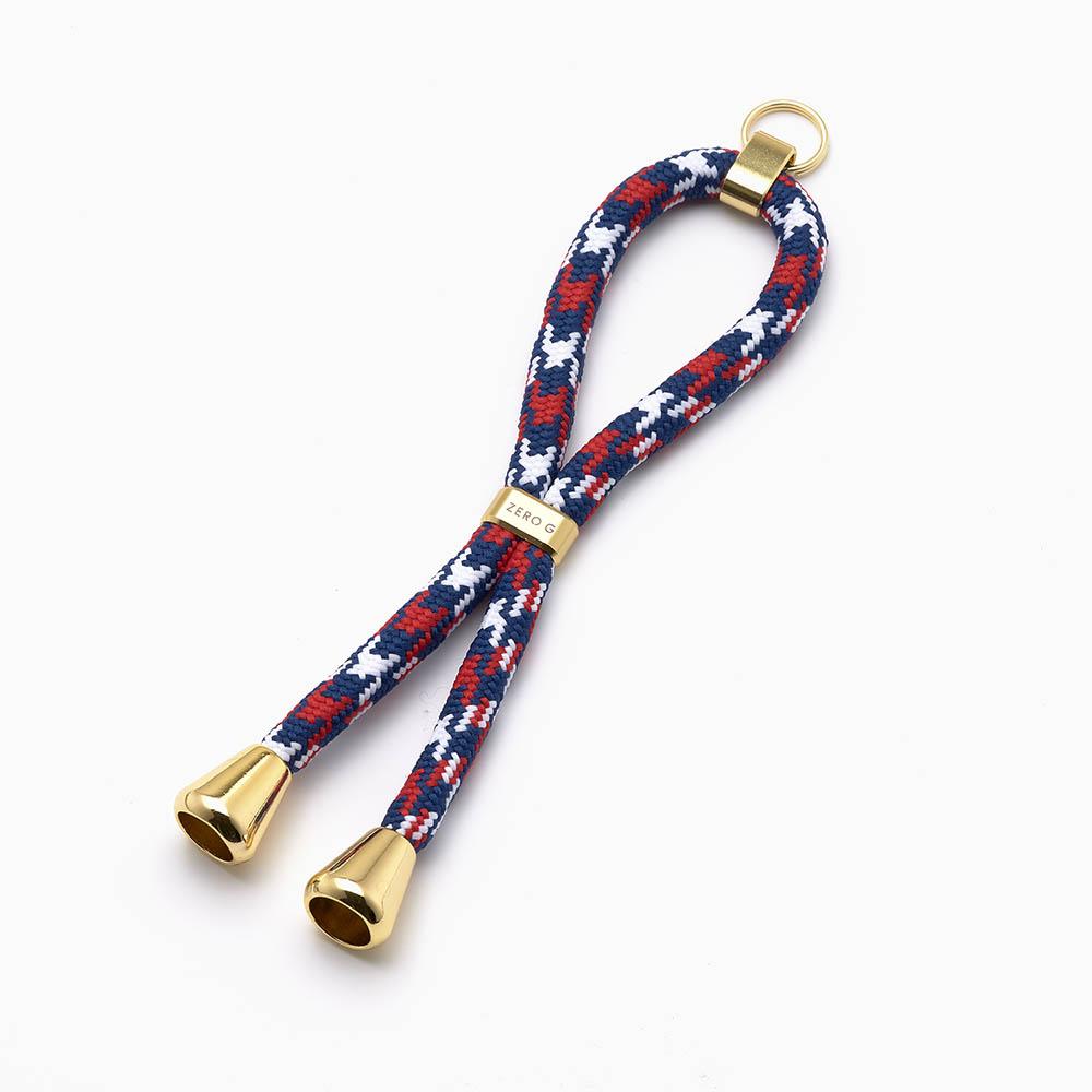 rot blau weiss gemusterter Schlüsselanhänger mit goldenem Slider und Endstücken.